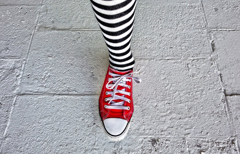 leg with striped sock and red shoe