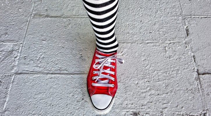 leg with striped sock and red shoe