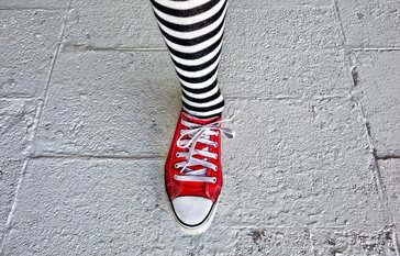 leg with striped sock and red shoe