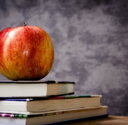 apple on top of stack of books