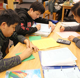 students working on school work at a table